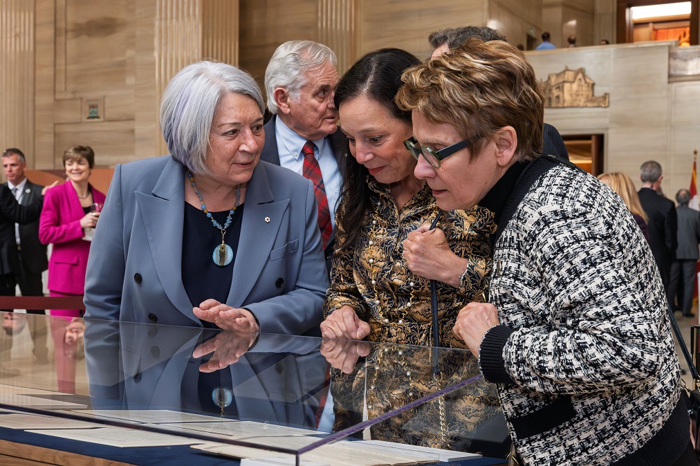 La gouverneure générale Mary Simon et la présidente du Sénat Raymonde Gagné visitent l’exposition avec Silvia Pecota, l’artiste qui a créé la pièce de monnaie commémorative de la Cour 