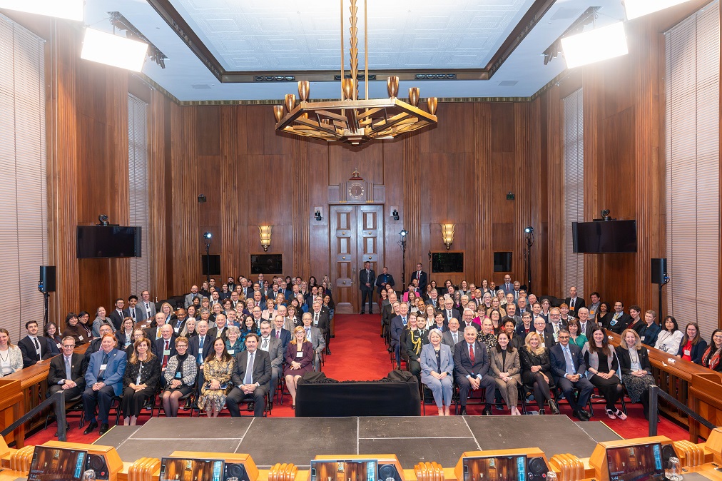 Les participants du symposium assis dans la salle d’audience principale, vu du banc des juges