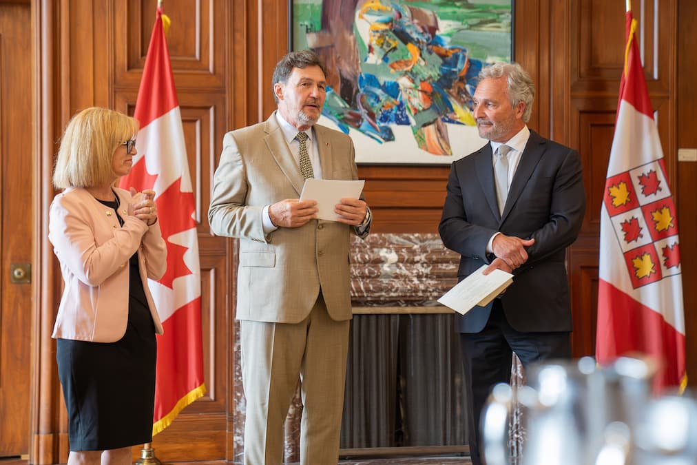 Chief Justice Richard Wagner, Registrar of the Supreme Court Chantal Carbonneau and Justice Glenn D. Joyal stand together.
