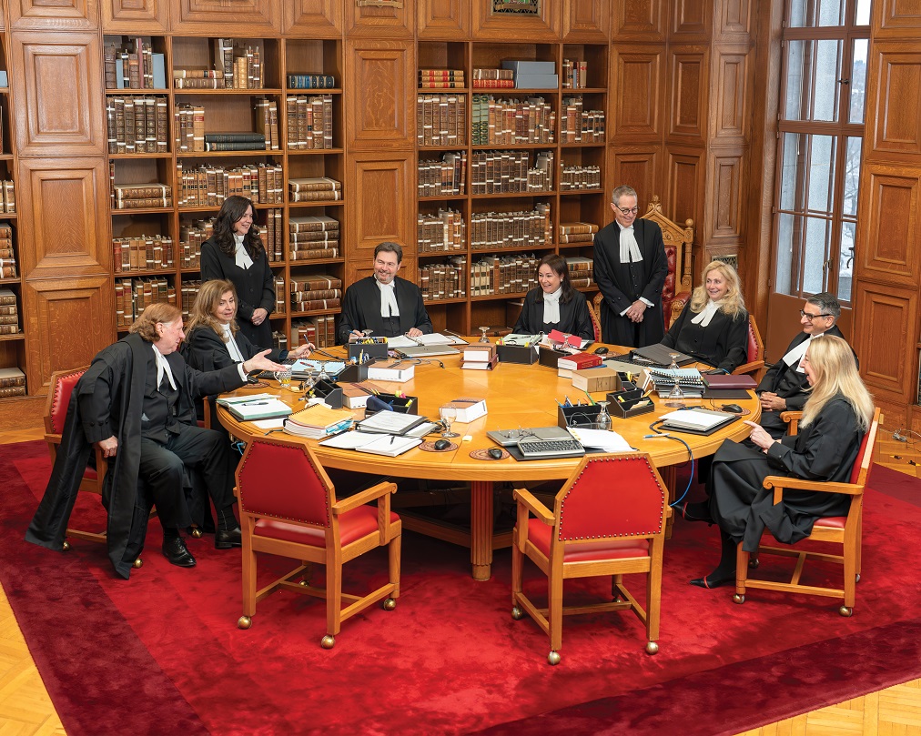 The 9 judges of the Supreme Court of Canada discussing around a table